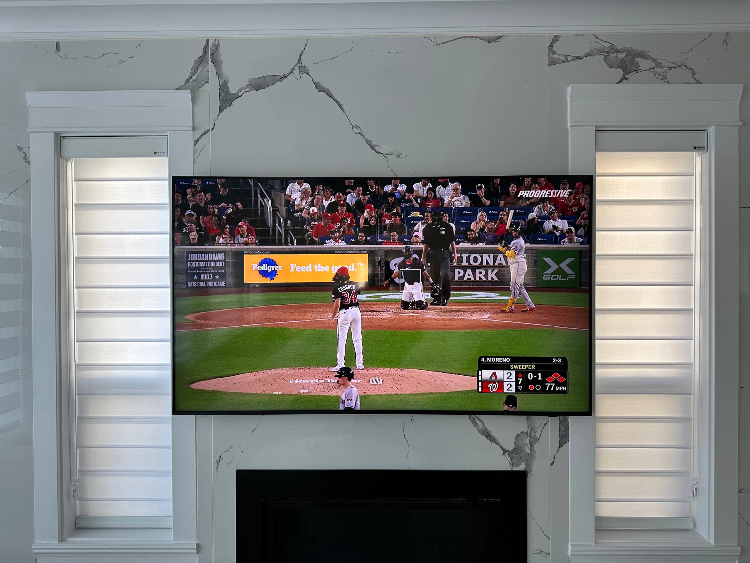 Wall-mounted television on a ceramic tile fireplace feature wall